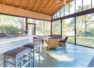 A newly constructed screened-in porch with a high wooden ceiling by Modern Construction Group Inc. in Orlando, FL.