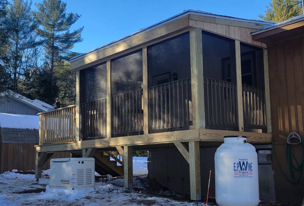 A screened-in porch under construction, showing the framing and screening, by Modern Remodel Build & Design in Worcester, MA.