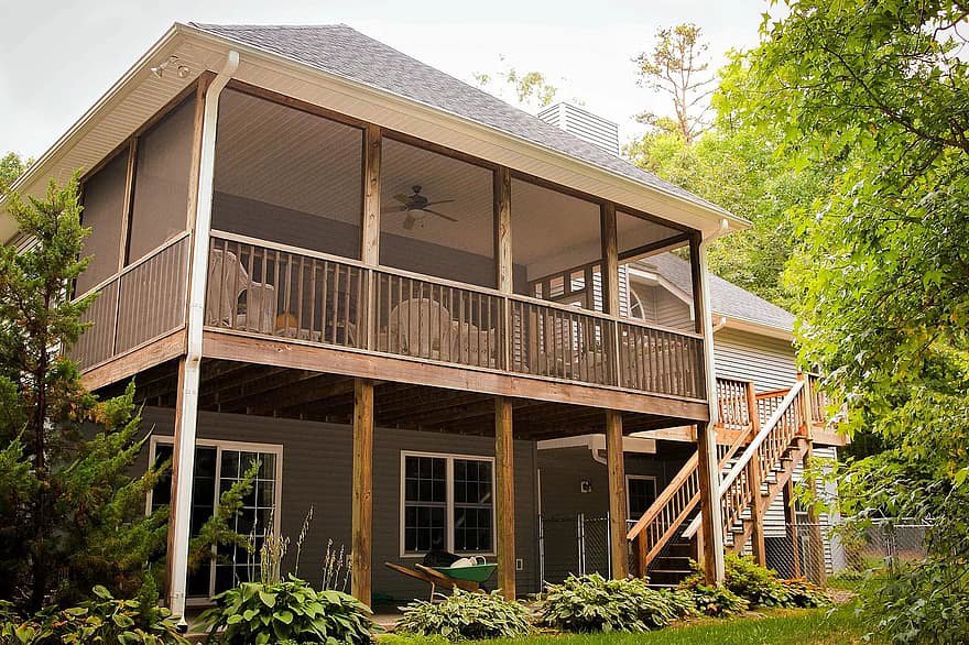A spacious screened-in porch and deck with stairs built by St. Charles Deck in St. Charles, MO