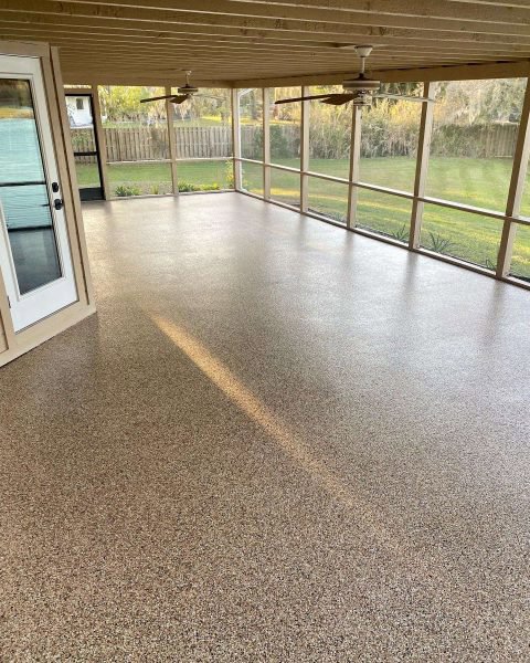 A beautiful brown flake epoxy floor on a screened-in patio by Floor Coating Specialist in St. Petersburg, FL.