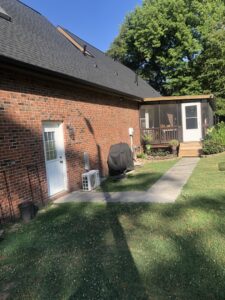 Back of a house with a newly installed door and screened porch by Lee's Painting in Northbrook, IL