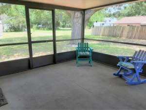 A spacious screened-in porch built by Knupper Properties & Knupper Homes, a general contractor in Clermont, FL.