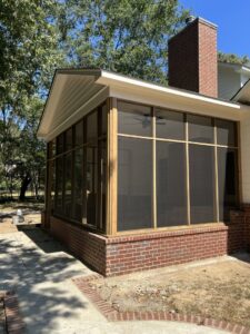 A newly constructed screened porch with a brick base and wooden framing by CMT Construction LLC in Columbia, MO.