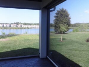 Interior view of a completed screened porch overlooking a lake by The Home Pros in Carson, CA.