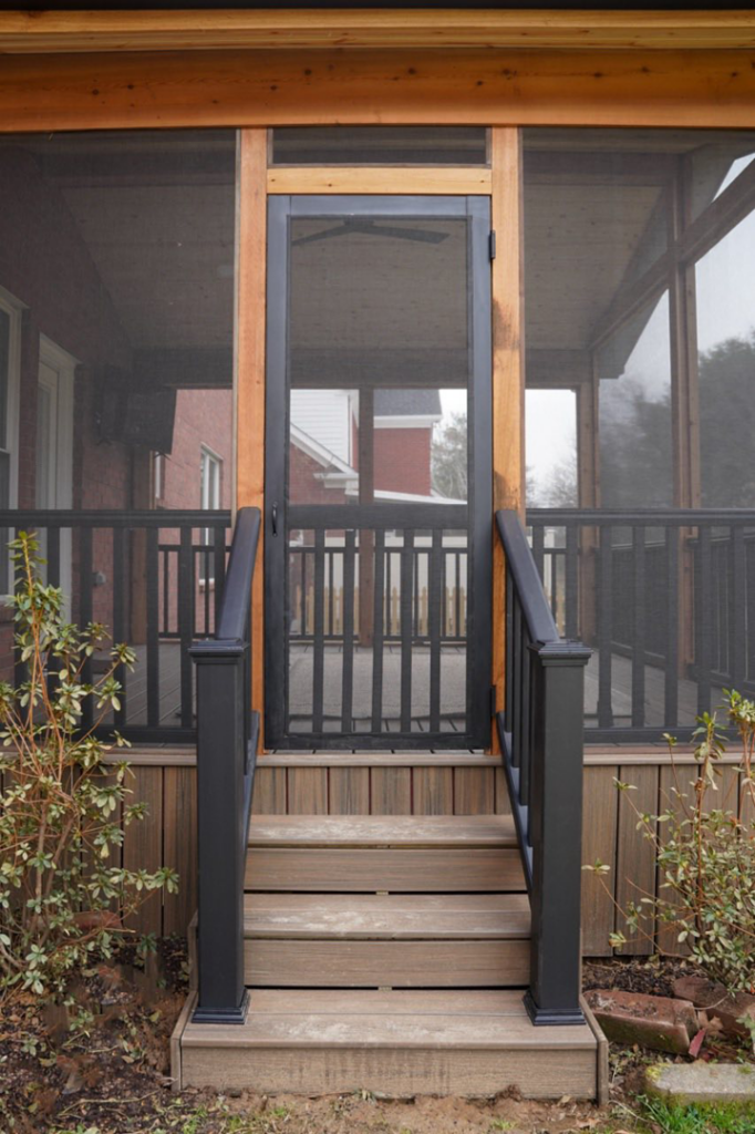 The entrance steps and screen door of a completed screened porch built by Vision Construction in Framingham, MA.
