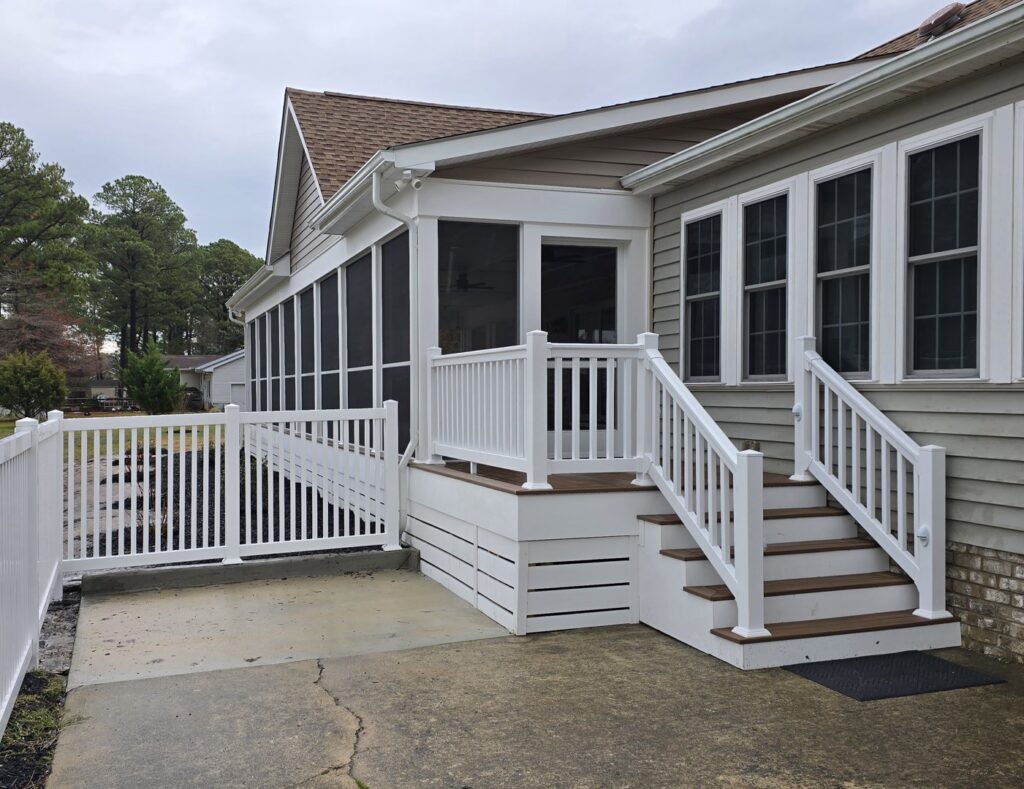 A completed screened porch with new steps and fence installation by M. Phippin Contracting in Hebron, MD.
