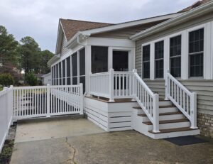 A completed screened porch with new steps and fence installation by M. Phippin Contracting in Hebron, MD.
