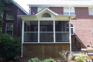 A completed screened porch featuring decorative lattice work underneath, installed by Screen Enc in Denver, NC