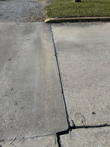 A sealed concrete expansion joint on a driveway by Gulf Coast Foundation Solutions in Lafayette, LA