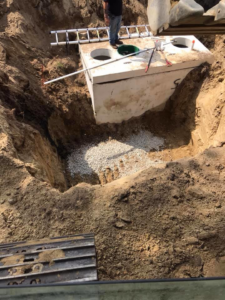 Excavation and installation of a septic tank by Us General, Inc. in Brockton, MA.
