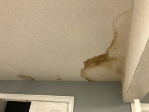 Severe water damage and stains on a ceiling before repair by Ceiling Doctor by Julian, a handyman service in Augusta, GA.