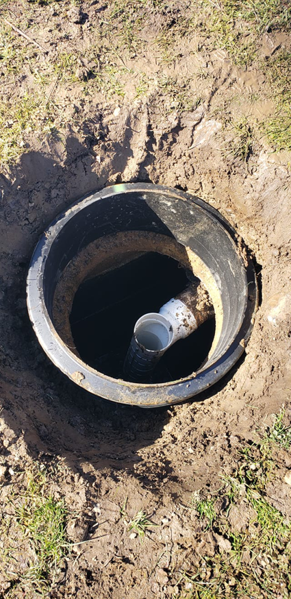 An open trench showing a sewer line access point for Advanced Rooter Plumbing in Norwalk, CT