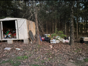 A shed overflowing with junk and additional items piled outside, awaiting removal by Junk Hawgs Removal and Rentals in Russellville, AR.