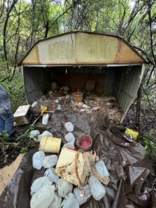 A dilapidated shed overflowing with trash and debris, indicating a major cleanout job by L.P.Z Trash & Junk Removal in Tallahassee, FL.
