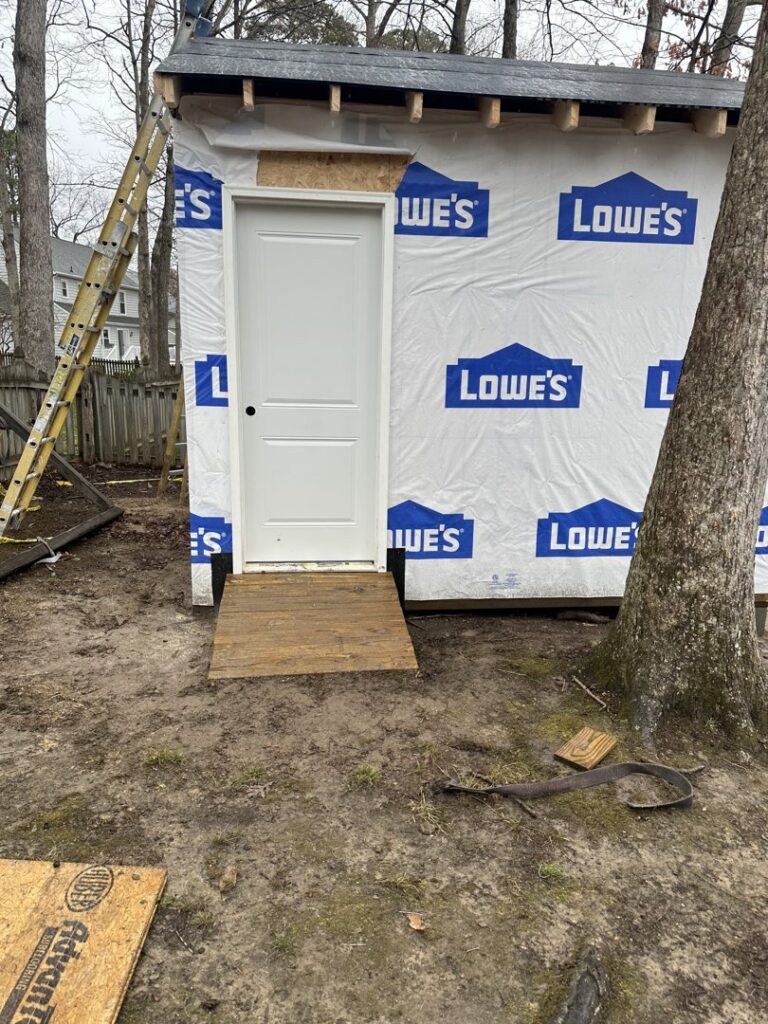Shed under construction with new door and ramp by Sanchez & Hall Construction in Richmond, VA.