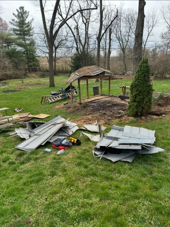 Debris from a demolished shed or small structure in a yard, ready for removal by Maddogg Junk Removal in Nicholasville, KY.