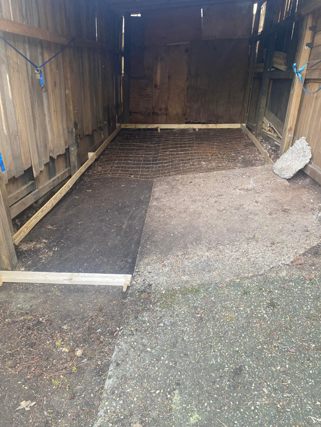 A shed floor prepared with rebar mesh and wooden forms for concrete by B&H Homes in Shreveport, LA