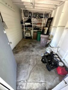 The interior of a shed with some items on shelves and a few on the floor, representing a shed cleanout service by Junk-O-Haulics in Westmoreland, TN.