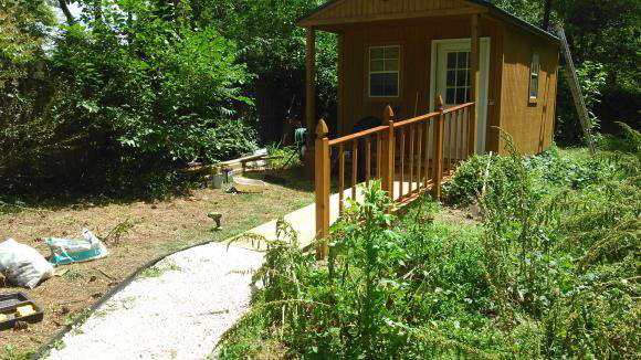 A newly constructed wooden ramp and gravel path leading to a shed by Randolph Residential Repair in Durham, NC.