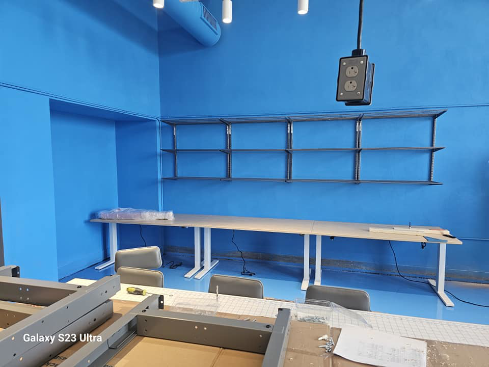 Newly installed wall shelves and furniture assembly in a room with blue walls by Logical Drywall and Painting in St. Louis, MO.