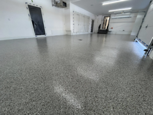 A shiny, grey speckled epoxy garage floor after professional installation by DuraFloor Epoxy Pros in Akron, OH.