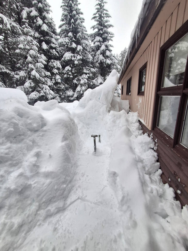 A neatly shoveled snow path alongside a building, provided by Palma Construction for snow removal in Paramus, NJ.