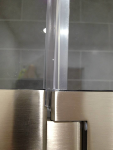Close-up of a modern shower door hinge and seal installed by Executech Interiors in Yonkers, NY