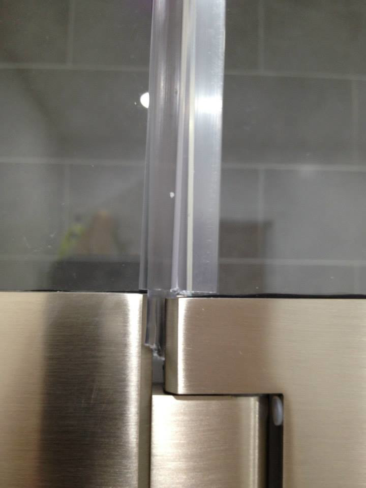 Close-up of a modern shower door hinge and seal installed by Executech Interiors in Yonkers, NY