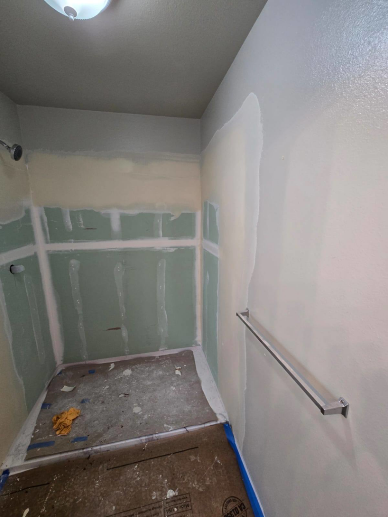Shower area with taped and mudded drywall, ready for tiling, and a towel bar installed by Fullhouse Builders LLC in Gig Harbor, WA