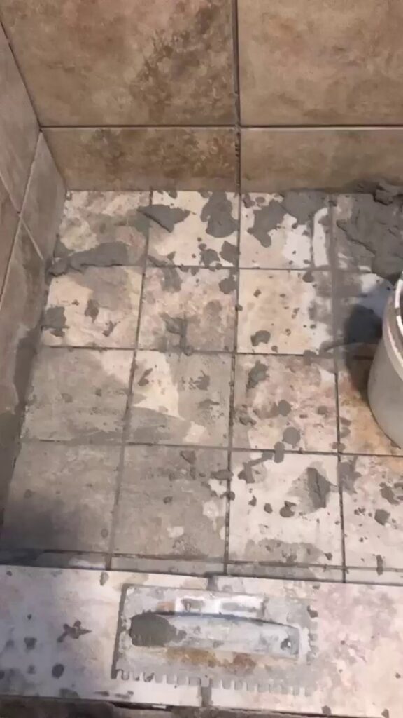 Shower floor tile installation in progress, showing mortar and tiles, by MDJ Handyman in Salt Lake City, UT.