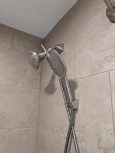 A modern shower head and handheld sprayer fixture professionally installed by H4 Construction and Remodeling in Blue Springs, MO.