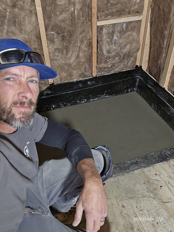 A general contractor installing a shower pan and waterproofing a bathroom at Bakoboy Enterprise Inc in Bakersfield, CA.