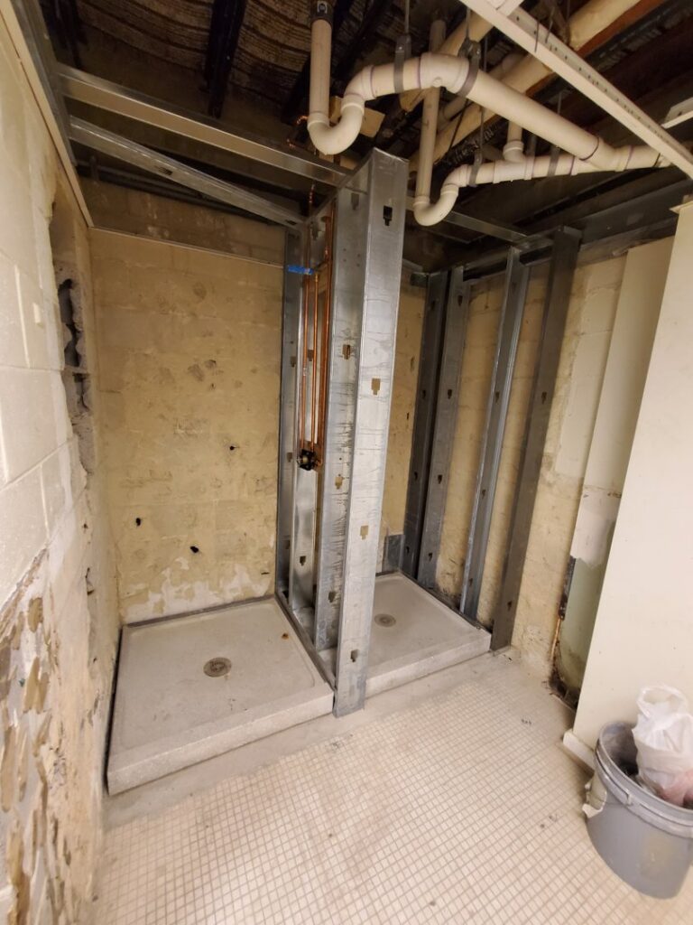 Shower plumbing rough-in installation in a commercial bathroom by Snyder Solutions LLC in Richmond, VA