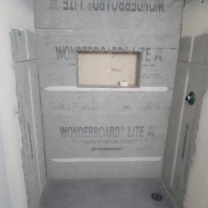 A shower stall with Wonderboard Lite cement board installed, ready for tiling by Tier 1 Contracting Inc. in Apache Junction, AZ.
