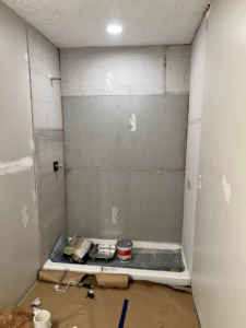 A shower stall under construction, showing cement board installed for tiling by Gardner Home Services in Pleasant Grove, AL.