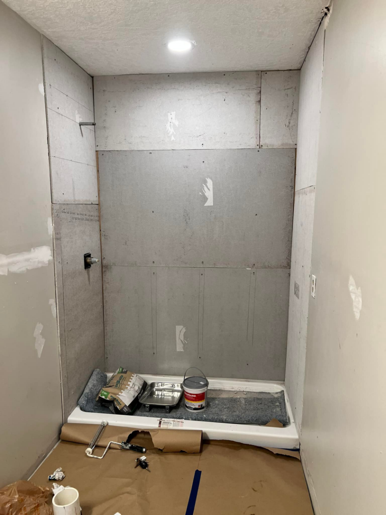 A shower stall under construction, showing cement board installed for tiling by Gardner Home Services in Pleasant Grove, AL.
