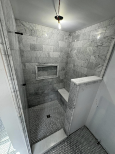 A shower under construction with marble-look subway tile installation by A&L Tile LLC in San Diego, CA