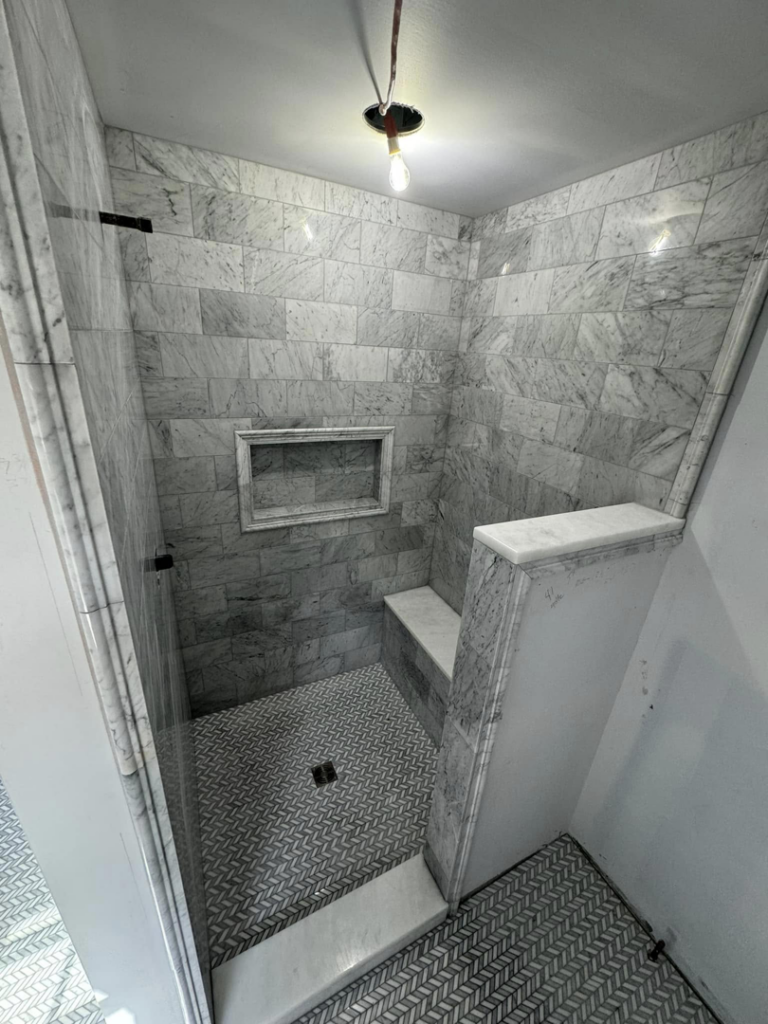 A shower under construction with marble-look subway tile installation by A&L Tile LLC in San Diego, CA