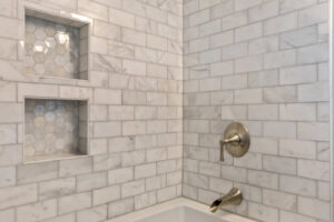 Detailed shower tile installation with built-in niches by Integrated Contracting and Renovations in Pittsburgh, PA.