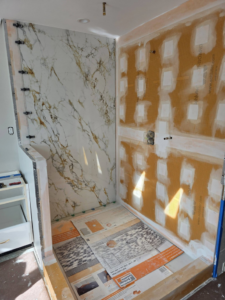 Shower tile installation in progress with waterproofing board visible by SG Homes LLC in Rockville, MD