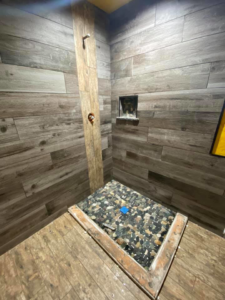 Shower wall and floor tile installation in progress by Quality Craftsman Construction in Longwood, FL.
