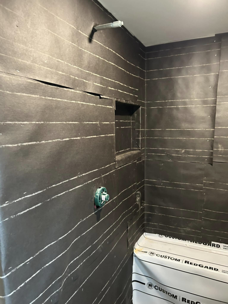 Shower walls with RedGard waterproofing membrane applied, ready for tiling by G-P Construction in Springfield, OR.