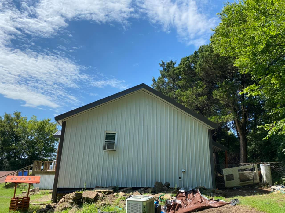 The side of a house showcasing new metal siding and a new roof installed by Sterling Renovations in Grapevine, TX.