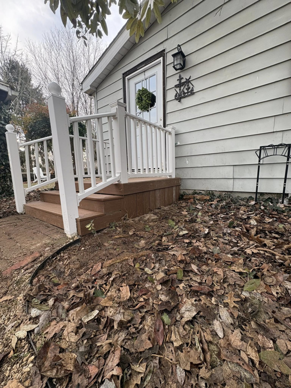 A side view of a newly built brown wooden porch with white railings by Savage Home Builders in Hodgenville, KY