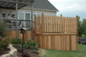 Side view of a newly constructed wooden deck with a privacy fence by Holm Remodeling Company in Kansas City, KS.
