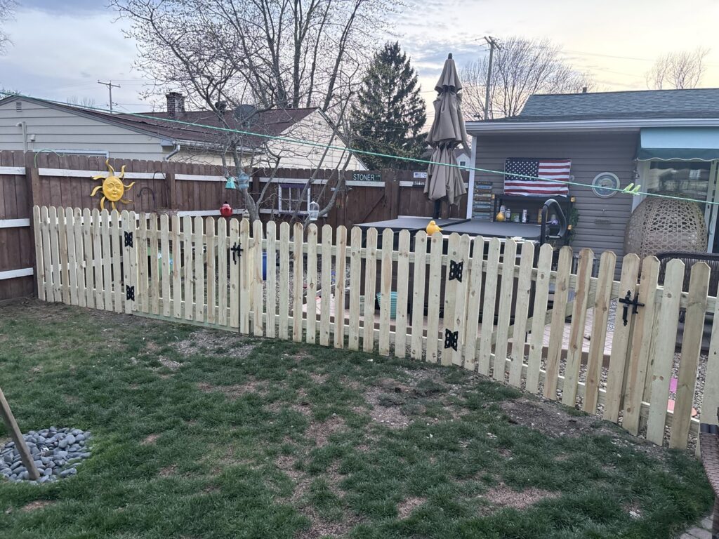 A new wooden privacy fence installed along the side of a house by Ofandiski Fence Co. Inc in Lorain, OH.