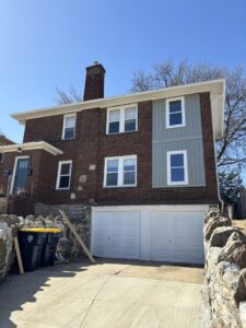 New vertical siding installation on a brick house by Rios Siding & Windows in Blue Springs, MO