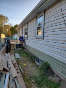 Exterior of a house with old siding removed and new furring strips installed, preparing for new siding by GCB Home Improvement in Appleton, WI.