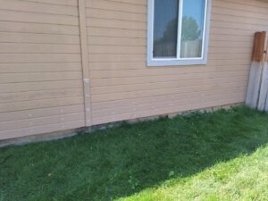 Repaired siding on a house, showing patched areas ready for finishing, a handyman service by Fix Idaho LLC in Meridian, ID.