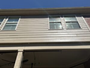 Newly replaced siding on a house, showcasing clean lines around the windows by Music City Exteriors in Nashville, TN